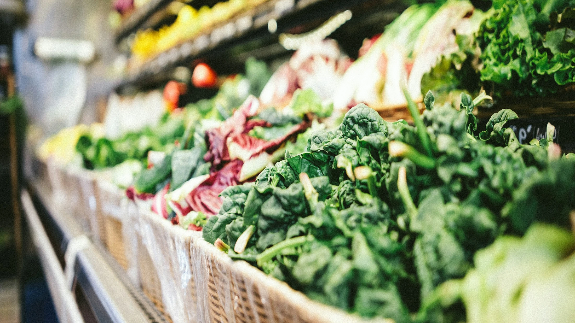 Crates of leafy green vegetables at a market